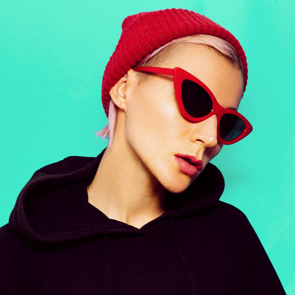 Blonde Model in fashionable sunglasses and beanie. Urban street  - Photo, image