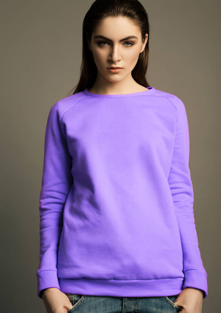 Beautiful fashion model with violet purple jumper - 写真・画像