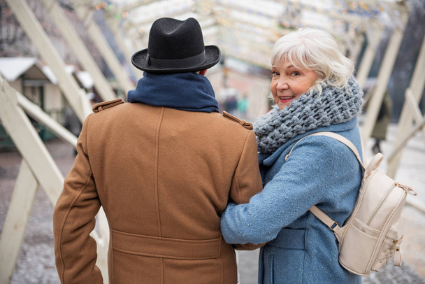 Joyful senior lady enjoying walk with her husband - Fotografie, Obrázek