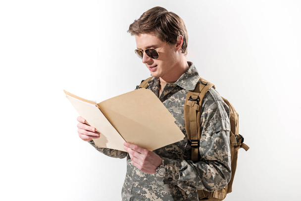 Serene young soldier exploring data in folder - Fotografie, Obrázek