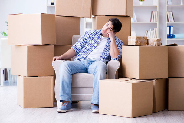 Young man moving in to new house with boxes - 写真・画像