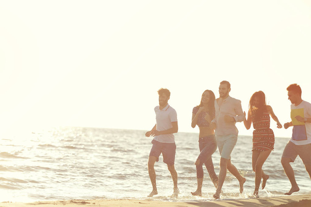 Amigos diversión en la playa bajo la luz del sol puesta del sol
. - Foto, Imagen