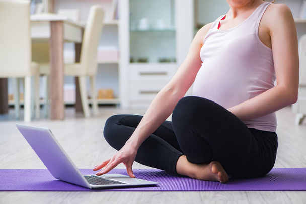 Pregnant woman exercising in anticipation of child birth - Foto, imagen