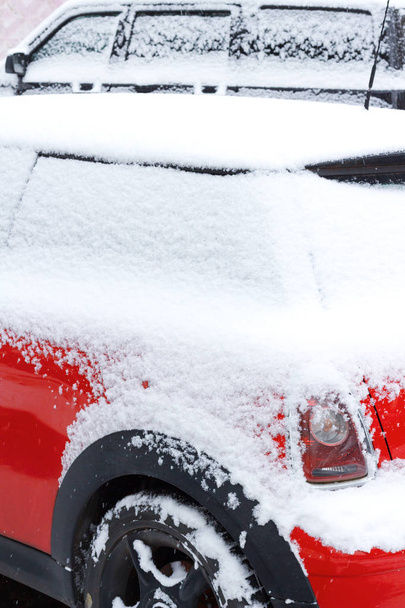 Snow-covered red car on parking in winter - Fotografie, Obrázek
