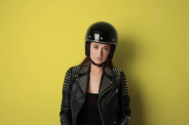 Attractive woman a motorcyclist with black retro helmet with opened shield system, isolated on isolated background. - Φωτογραφία, εικόνα