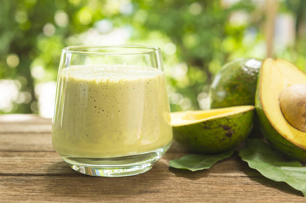 avocado Smoothie on a wooden table with dark wood background. - Foto, immagini