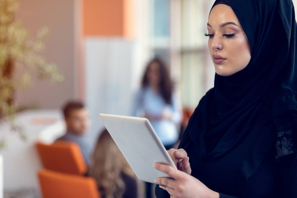 Pretty woman wearing hijab in front of laptop search and doing office work, business, finance and workstation concept. - Foto, immagini