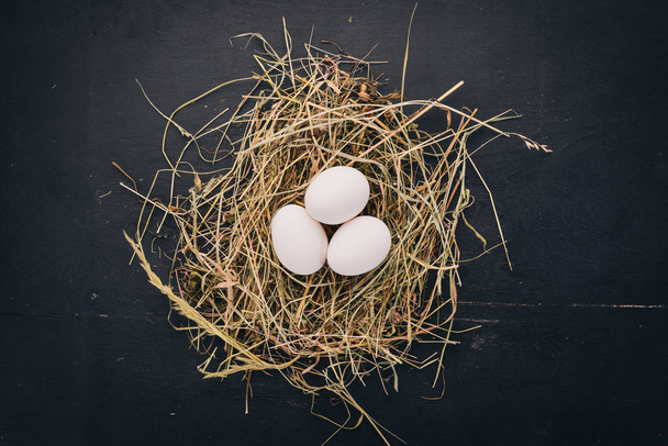 Chicken raw white eggs. On a wooden background. Top view. Copy space. - Фото, изображение