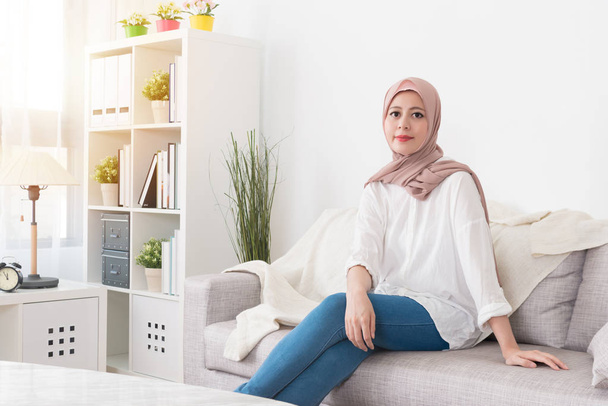pretty elegant muslim woman sitting on sofa couch - Foto, Imagem