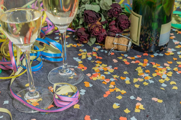 Champagne glass and bottle with carnival decoration on a slate - Foto, Imagem