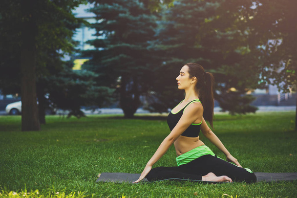 Woman training yoga in twisting sage pose. - Φωτογραφία, εικόνα