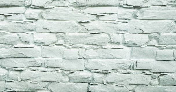 Fondo de pared de piedra. Textura de pared de piedra pintada blanca como fondo. Pintura de pared de fondo
. - Foto, imagen