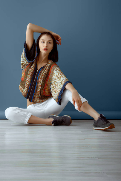 Calm hippie girl sitting on the floor - Фото, изображение