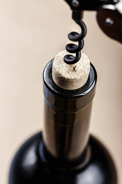 corkscrew in a bottle of wine - Fotó, kép