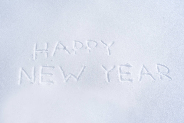 Hyvää uutta vuotta kirjoitettu lumessa
 - Valokuva, kuva