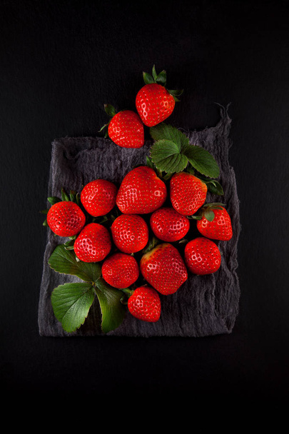 fresh ripe strawberries on a napkin and slate plate kitchen table can be used as background - Fotografie, Obrázek