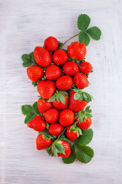 fresh ripe strawberries on white wood plate kitchen table can be used as background - Photo, image
