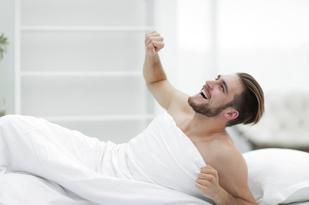 smiling man waking up in the morning - Φωτογραφία, εικόνα