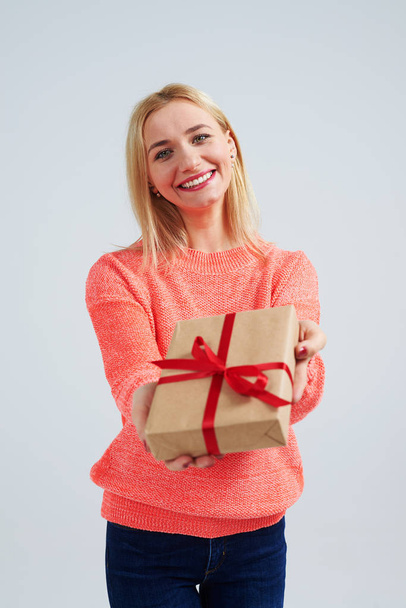 young blond smiling and holding gift - Foto, Imagen