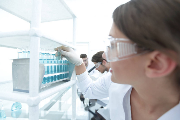 Young woman with test tubes in the laboratory - Foto, Imagen