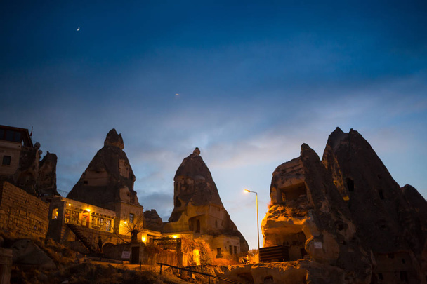 Night scene of the Uchisar Castle in Cappadocia. Illuminated view of famous Uchisar village, district of Nevsehir Province in the Central Anatolia Region of Turkey, Asia. - Photo, Image