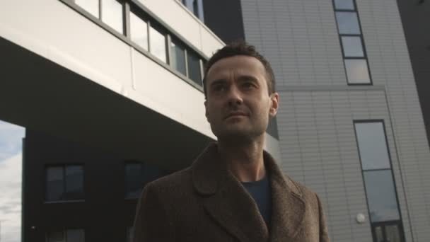 Around the stylish modern man looking forward standing at the business center - Video, Çekim