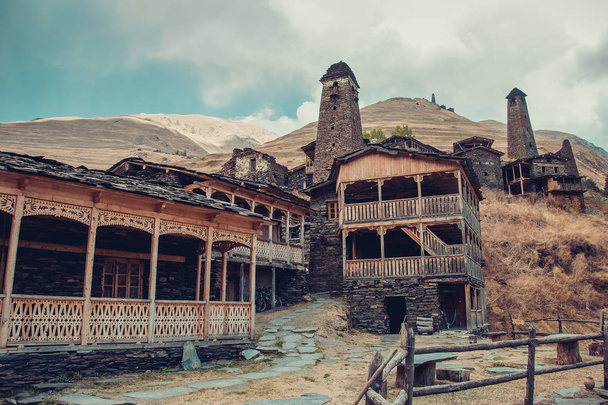Small village Dartlo with traditional stone buildings and defensive towers in Tusheti. Adventure holiday. Travel to Georgia. Green ecology tourism. Eco trekking tour. Balcony decorated with fretwork - Fotó, kép