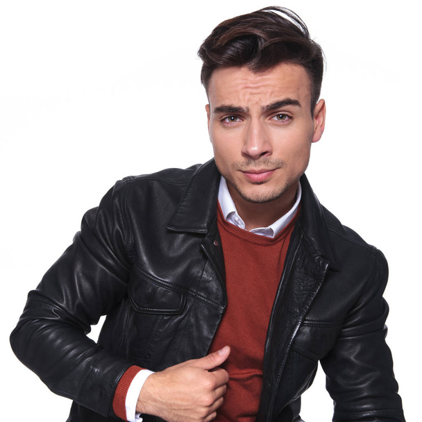 smart casual man in leather jacket holds collar  - Фото, изображение