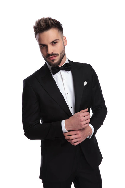 elegant man in tuxedo fixing his sleeve - Фото, изображение
