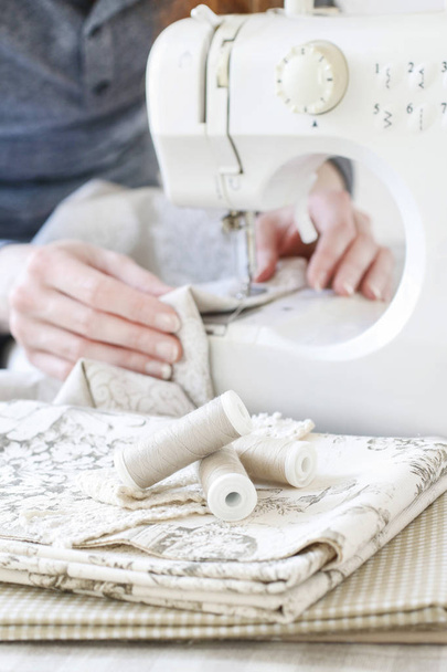 Woman using sewing machine - Fotó, kép