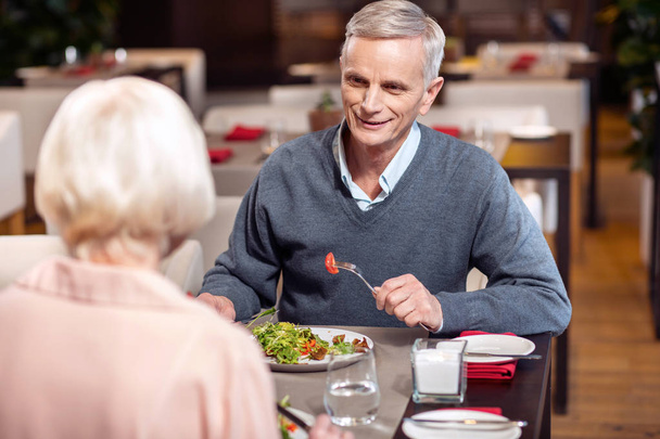 Joyful mature man enjoying dinner - Фото, изображение