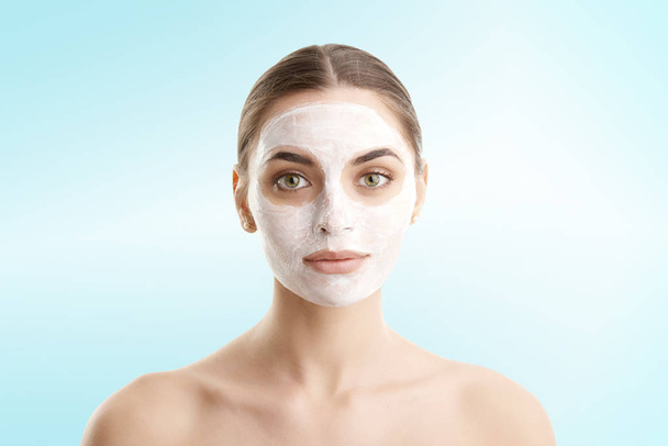 Studio shot of young woman with  face mask against at isolated background with copy space.  - Foto, Imagen