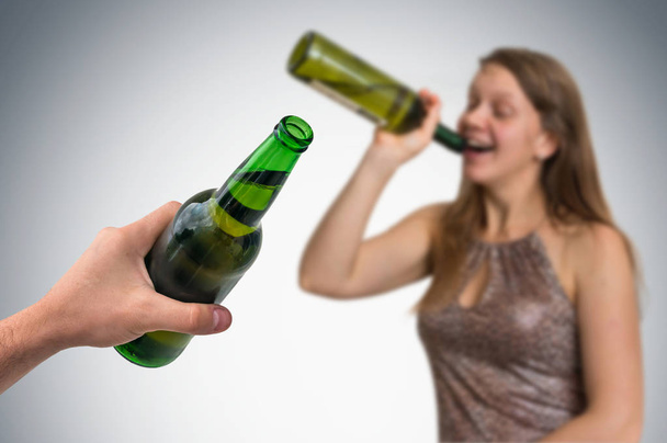 Unfocused woman drinking alcohol and hand of man with beer - Фото, изображение