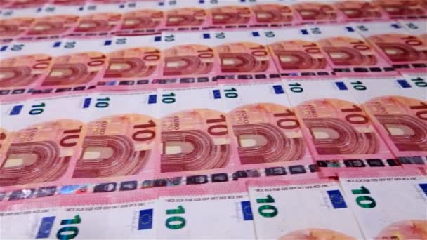Close up of movement along ten euro banknotes layer arranged in rows - Footage, Video