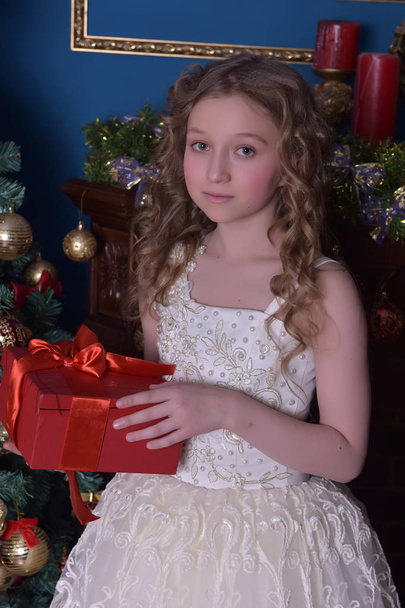 girl in a smart white dress at a Christmas tree - Zdjęcie, obraz