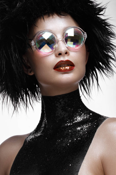 Beautiful fashion woman with creative make-up, wig and color glasses . beauty face. - Foto, Bild