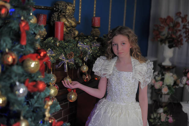 girl in a smart white dress at a Christmas tree - Фото, зображення