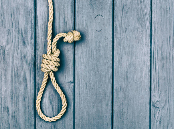 Hinge for the gallows on a blue wooden background. - 写真・画像