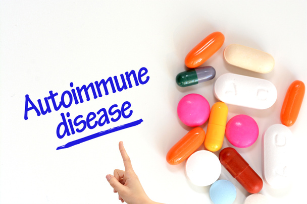 Autoimmune disease on white background near colorful pills or drugs - Photo, Image