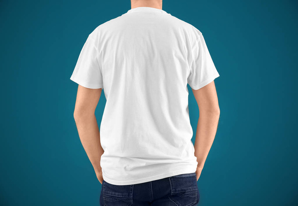 Young man in stylish t-shirt on color background. Mockup for design - Fotoğraf, Görsel