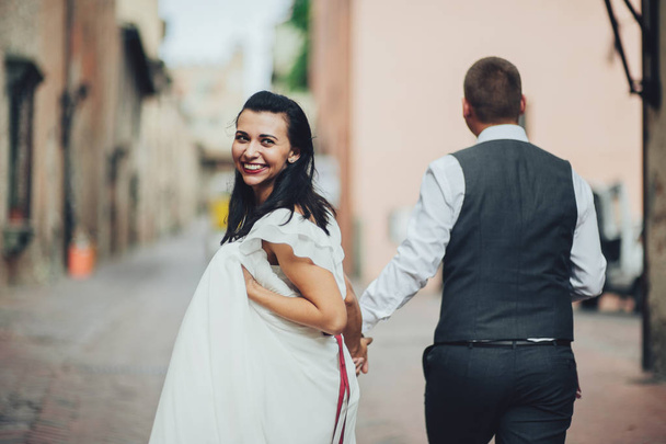Romantic couple walking on old town streets - 写真・画像