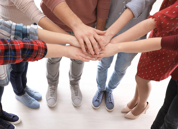 Young people putting hands together as symbol of unity - Φωτογραφία, εικόνα