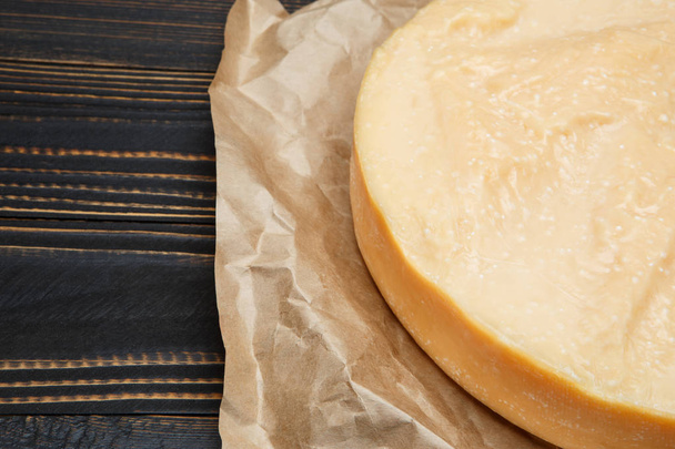 Whole round Head of parmesan or parmigiano hard cheese on wooden background - Foto, Imagem