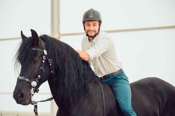 man in a shirt riding on a brown horse - Fotografie, Obrázek
