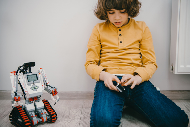 adorable little kid sitting on with diy robot - Foto, afbeelding