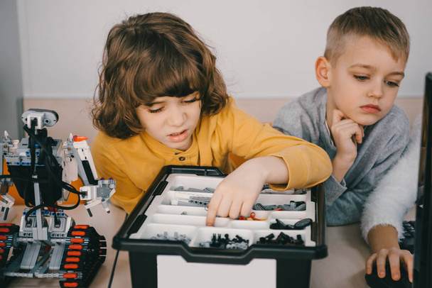 concentrated kids constructing diy robot, stem education concept - Foto, Imagem