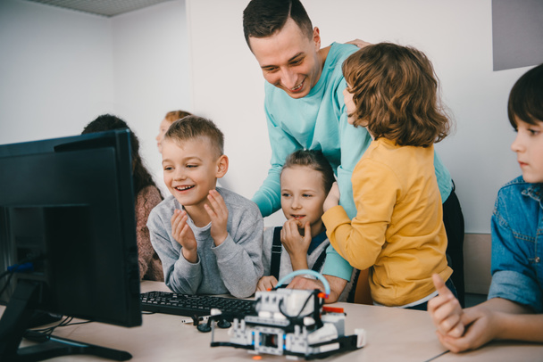leraar zijn tiener studenten helpen met diy robot op stam education klasse - Foto, afbeelding