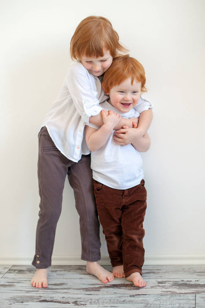 Brother and sister tightly embrace - Φωτογραφία, εικόνα