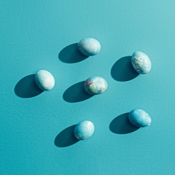 top view of blue shabby easter eggs, on blue with shadows - Photo, Image
