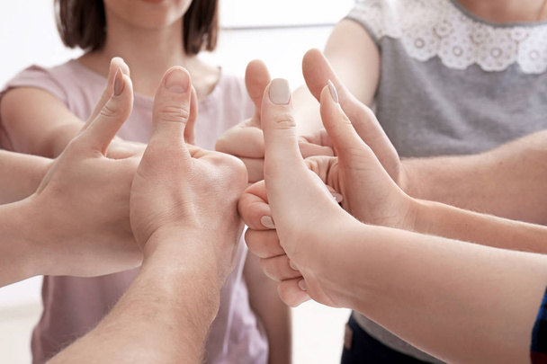 Group of people standing in circle and showing thumb-up gesture. Unity concept - Photo, Image